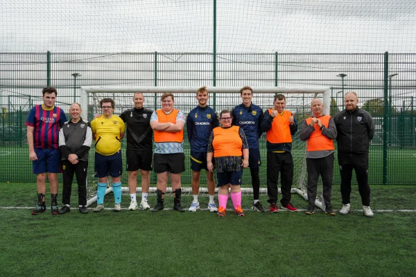 Stan Mills and Jamie Cumming pose for a team photo with our Inclusion team